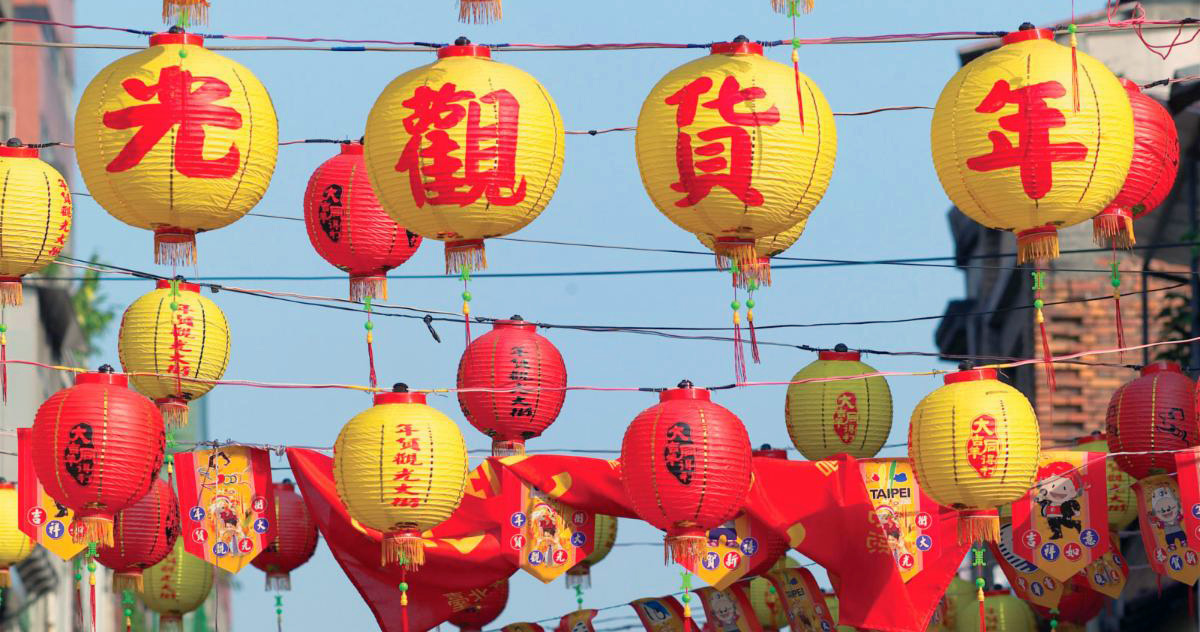 festive red and yellow Chinese lanterns strung across a street