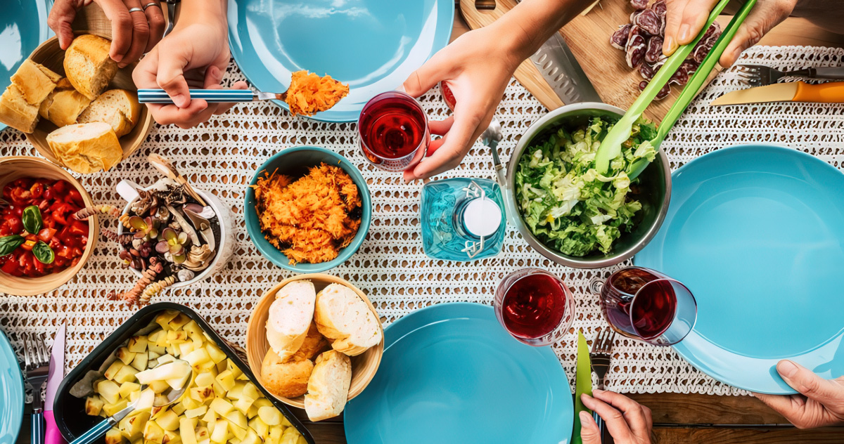 top view of brightly colored dishes and brightly colored food on a table